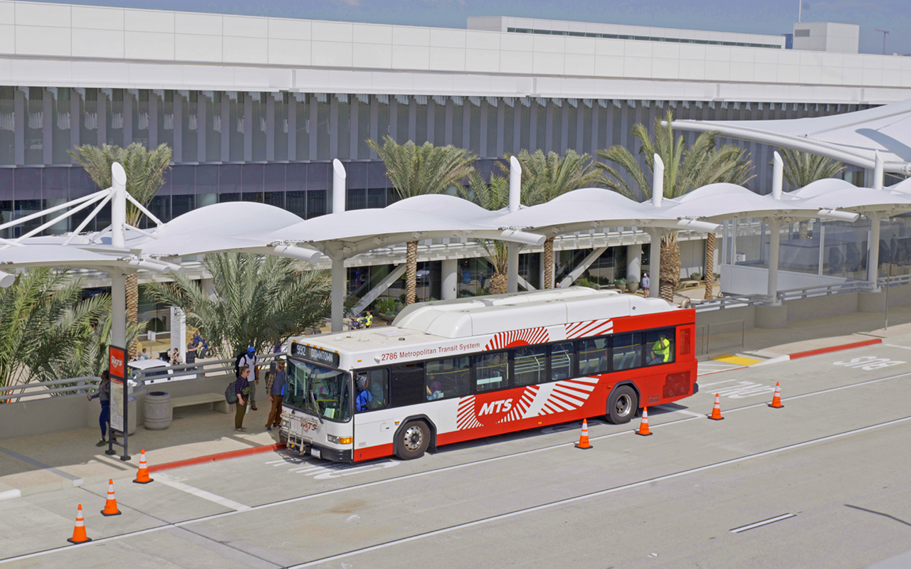 A rendering of a Route 992 MTS bus stopped at a bus shelter at the San Diego International Airport