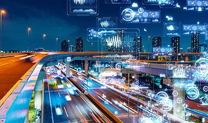 A nighttime photo of a freeway blurred with street lights and tall buildings silhouetted in the background. Slightly blurry white circular shapes and data graphics overlay the image.